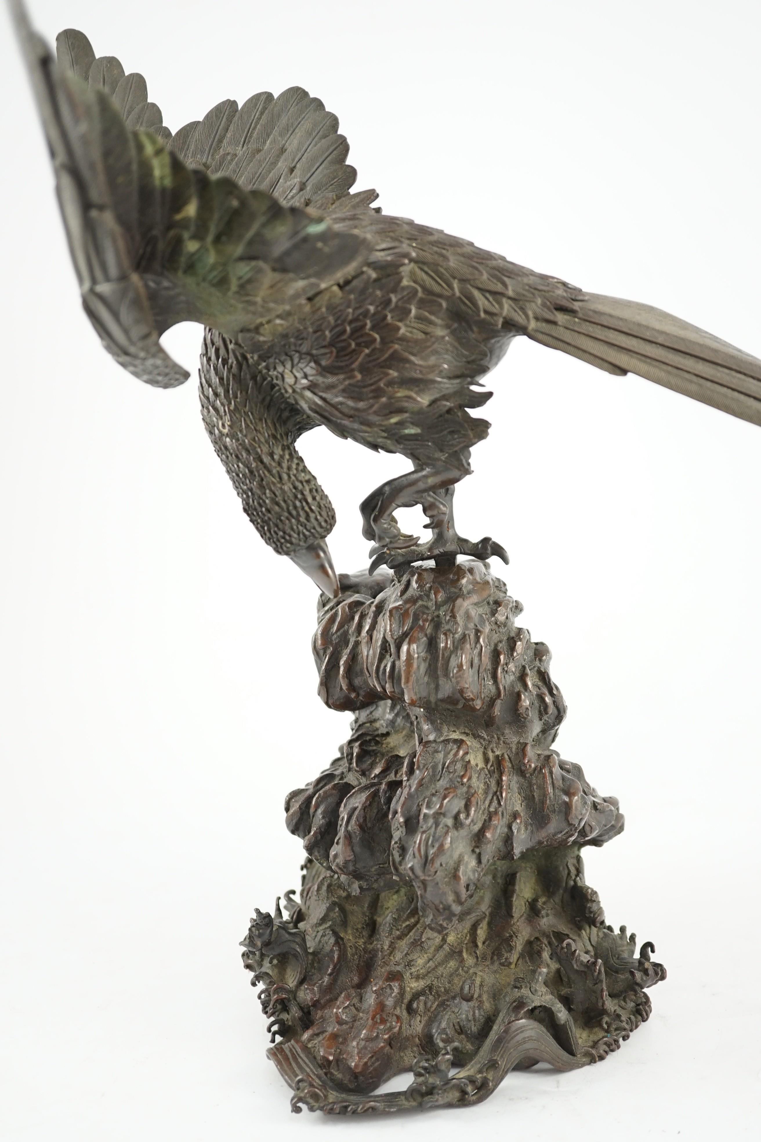 A Japanese bronze model an eagle standing on a rock, Meiji period, 44.5cm high